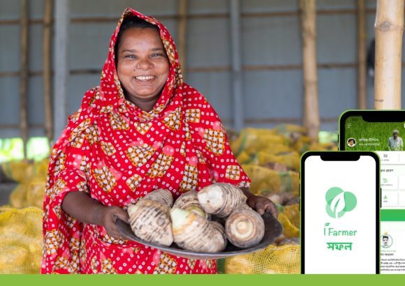 the image shows a woman smallholder farmer in Bangaldesh who who is a customer of iFarmer. It alsoshows the iFarmer app that smallholder farmers in the country use